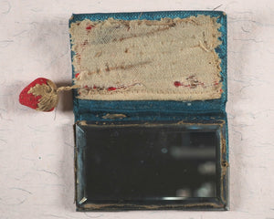 Needlecase 'blook'. Complete with attached bevelled pocket mirror and original 'blook' holder.
