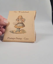 Load and play video in Gallery viewer, Carroll, Lewis, Invented by. Wonderland Postage-Stamp Case," [Alice with baby] [with] 12 separate pockets for stamps. Emberlin and Son, 4 Magdalen Street, Oxford. [1889].
