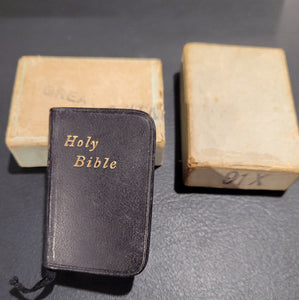 Holy Bible c1914  3/4" x 1 1/4"  Bound in black leather with gilt title to front cover and spine. Gilt edges.  Contained in an unmarked cardboard box