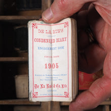 Load image into Gallery viewer, De La Rue&#39;s Improved Condensed diary and engagement book. &gt;&gt;FINGER SHAPED MINIATURE BOOK IN LAVISH SILVER SLIPCASE&lt;&lt; Publication Date: 1905 CONDITION: VERY GOOD
